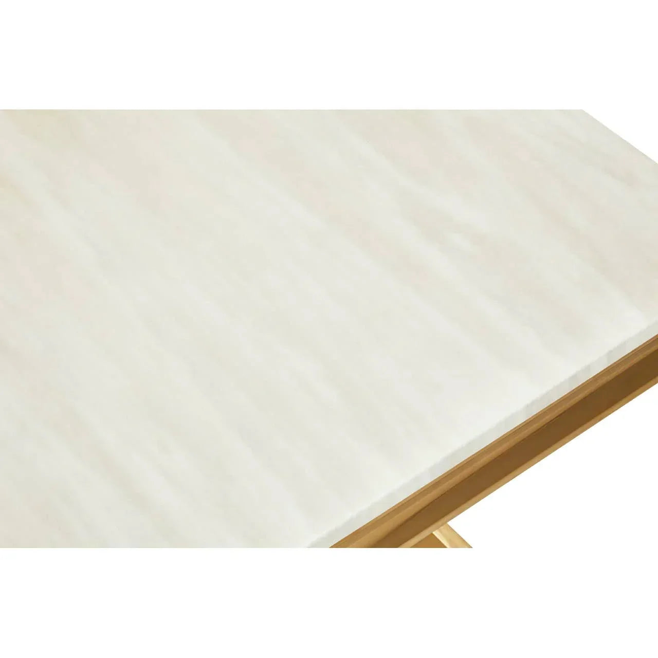 Closeup of rectangular dining table with cream marble top and gold metal edge