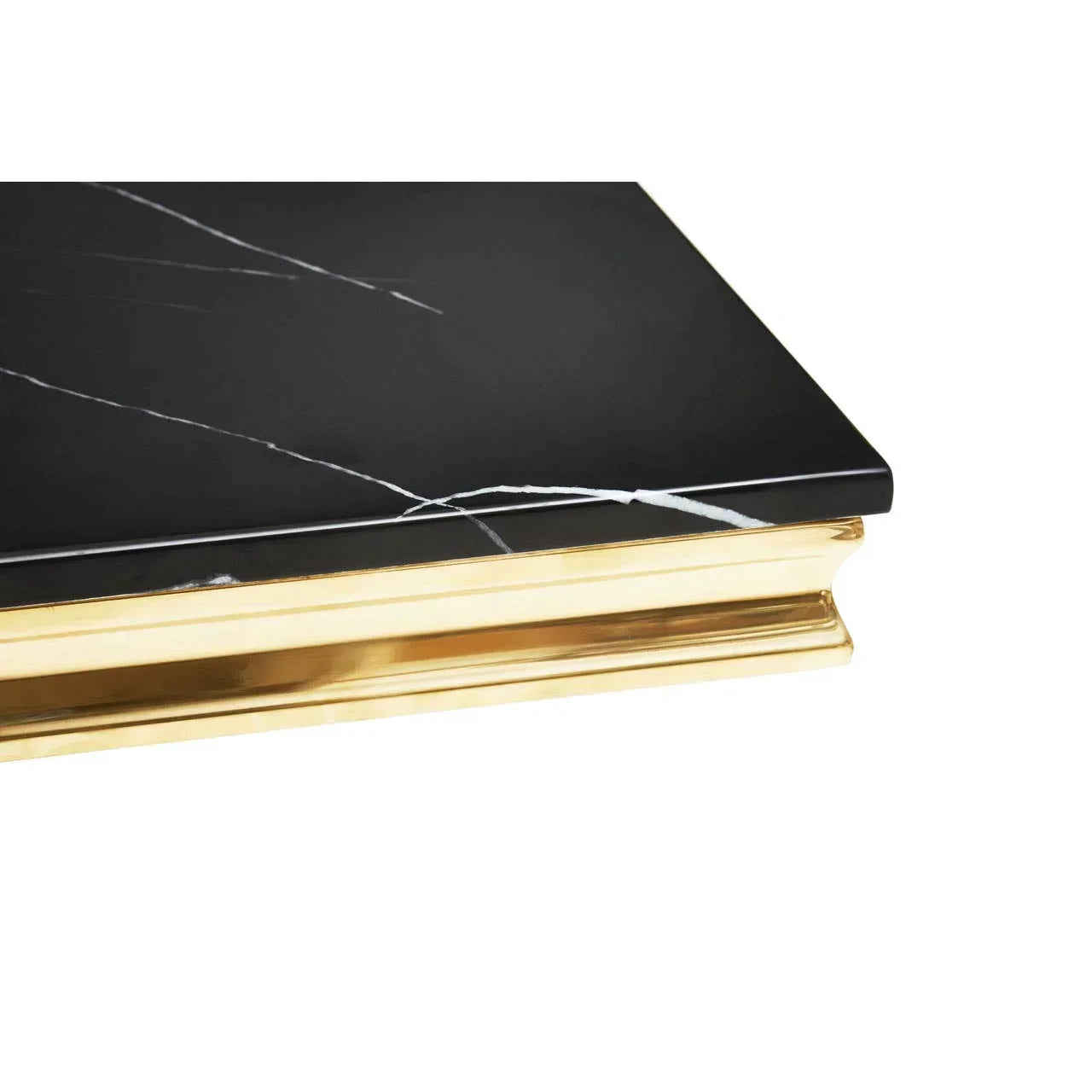 Black marble tabletop with gold metal edge and white veining, close-up corner view