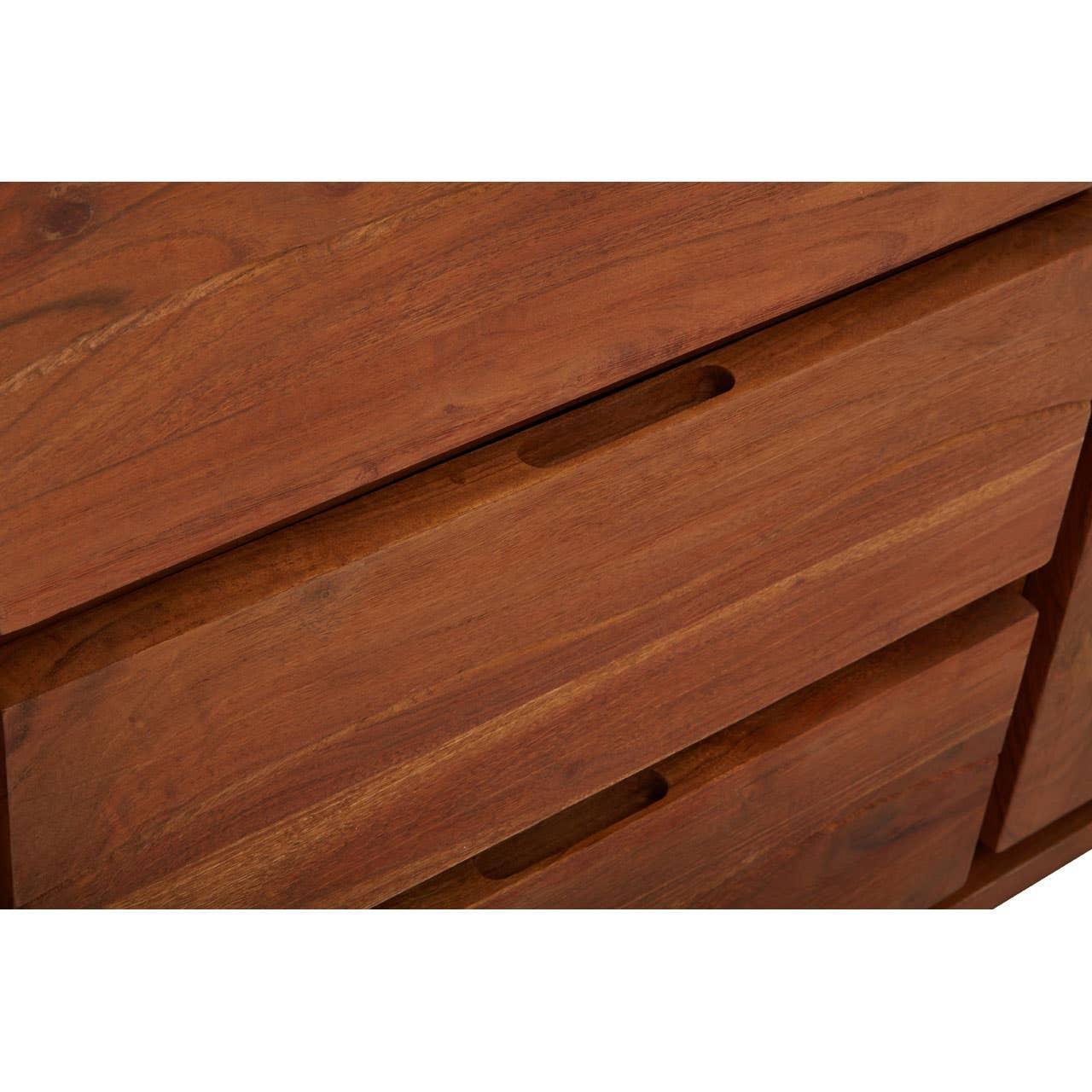 Close-up of wooden chest of drawers with integrated handle cutouts