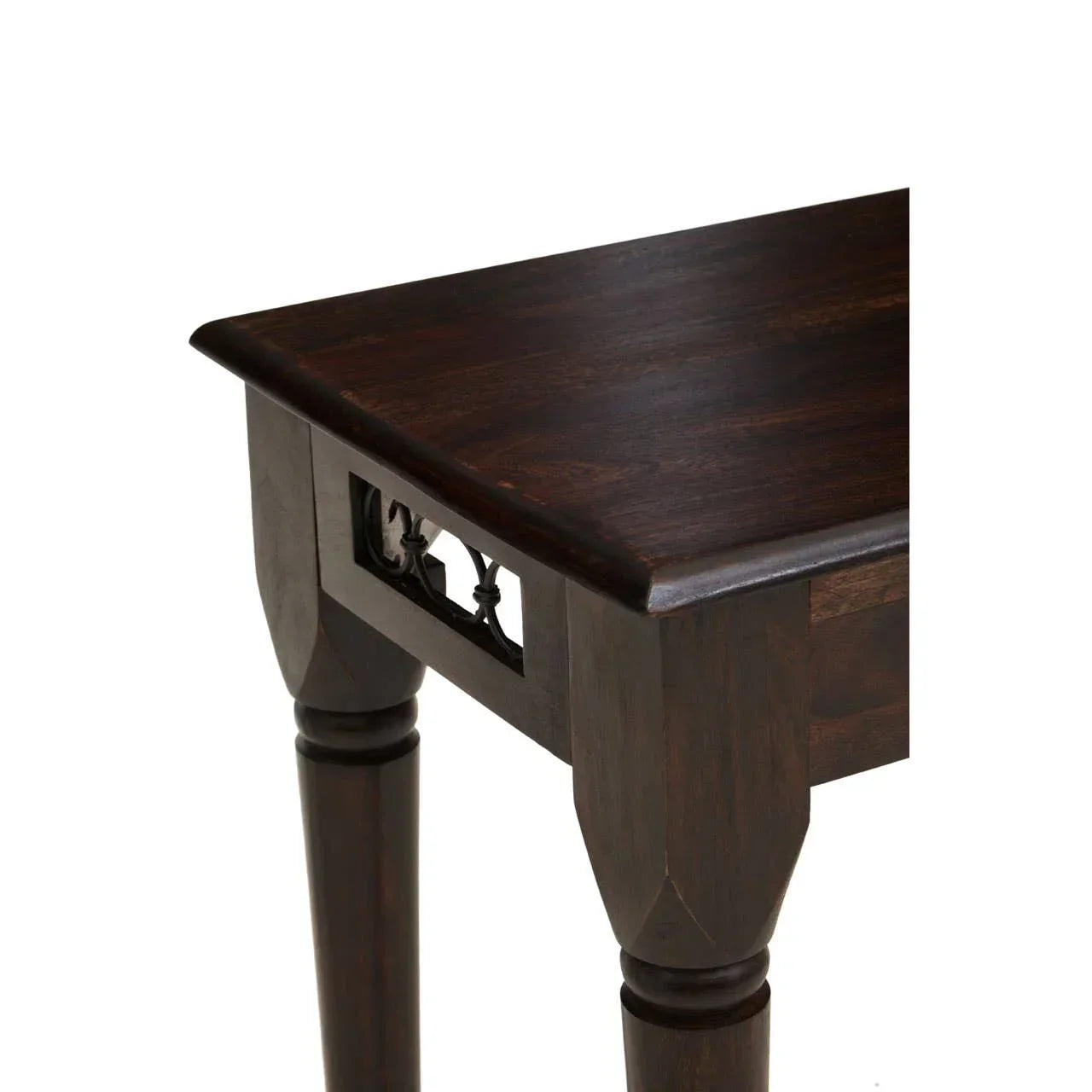 Dark wood coffee table corner with carved leg detail and decorative apron