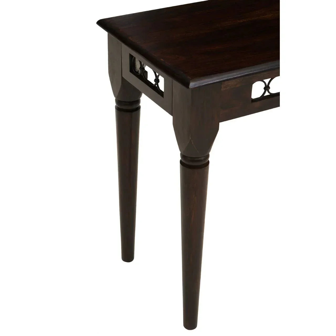 Dark wood table corner with carved detail and tapered legs
