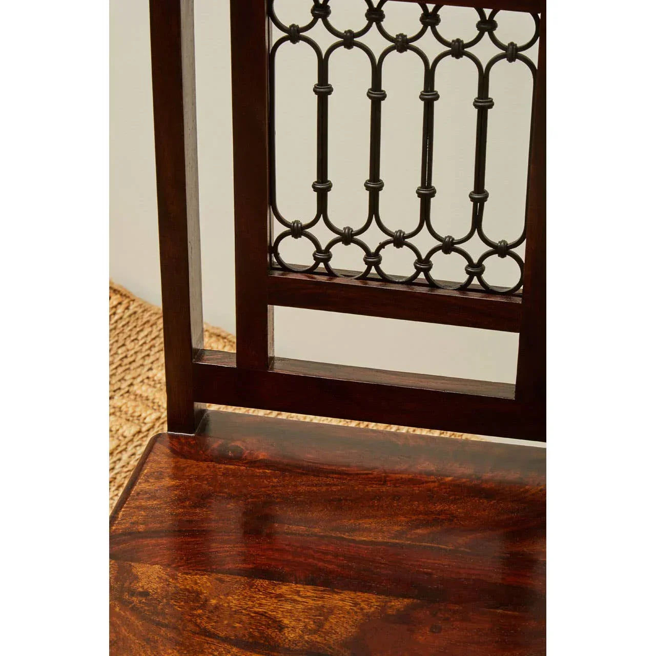 Dark wood dining chair with decorative metal backrest and glossy seat finish