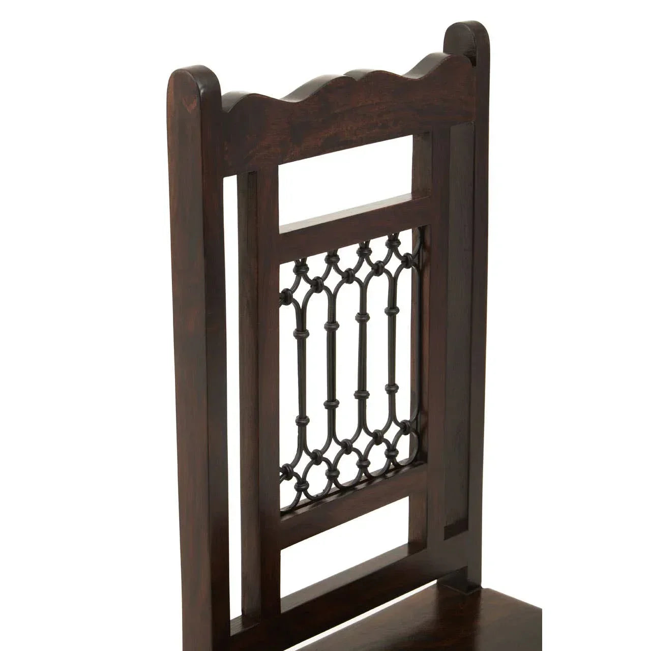 Dark wood dining chair backrest with decorative metalwork detail