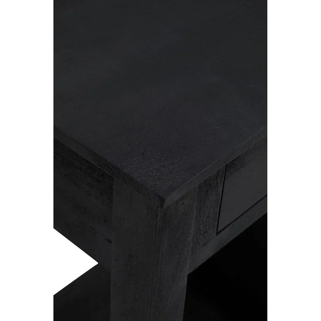 Close-up of black wooden table corner with visible textured grain and sturdy leg