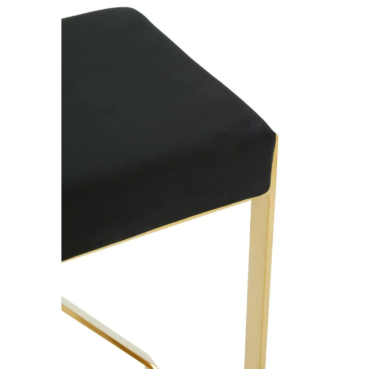 Black dining chair seat with gold metal legs, close up of upholstery and frame