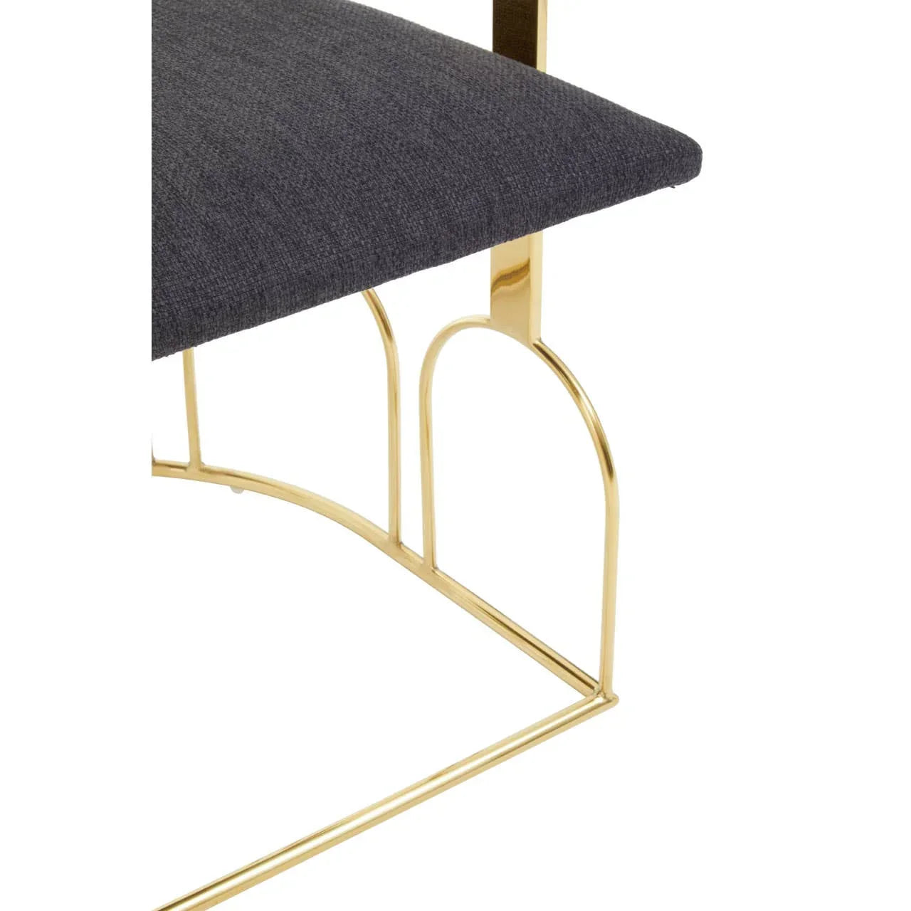 Gold metal chair frame with dark fabric upholstered seat, close-up side view
