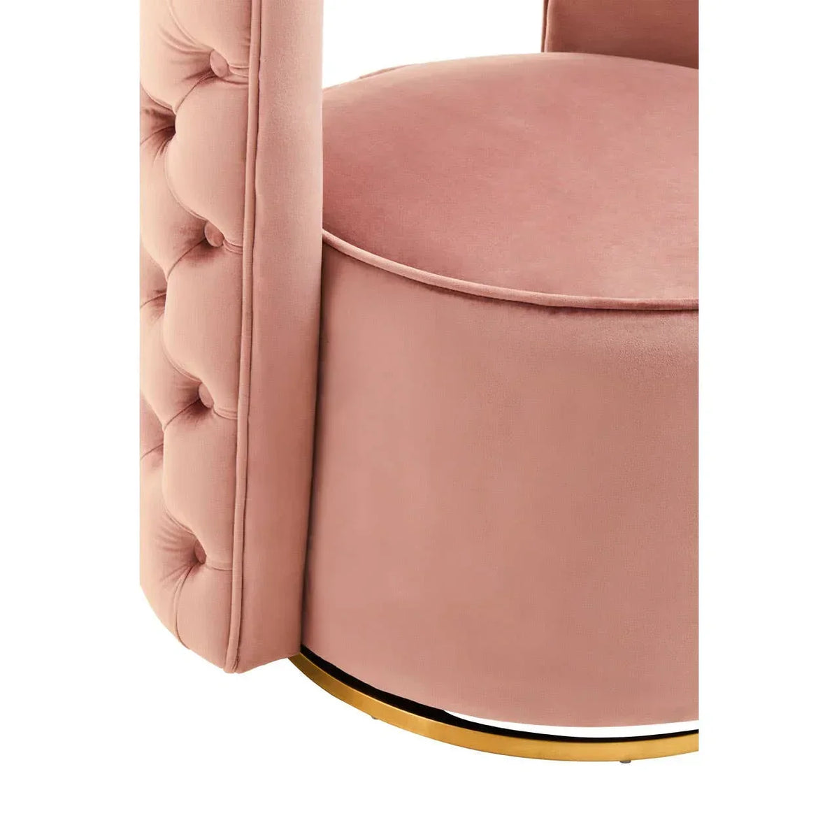 Blush pink velvet armchair with buttoned side detail and gold base, close-up view