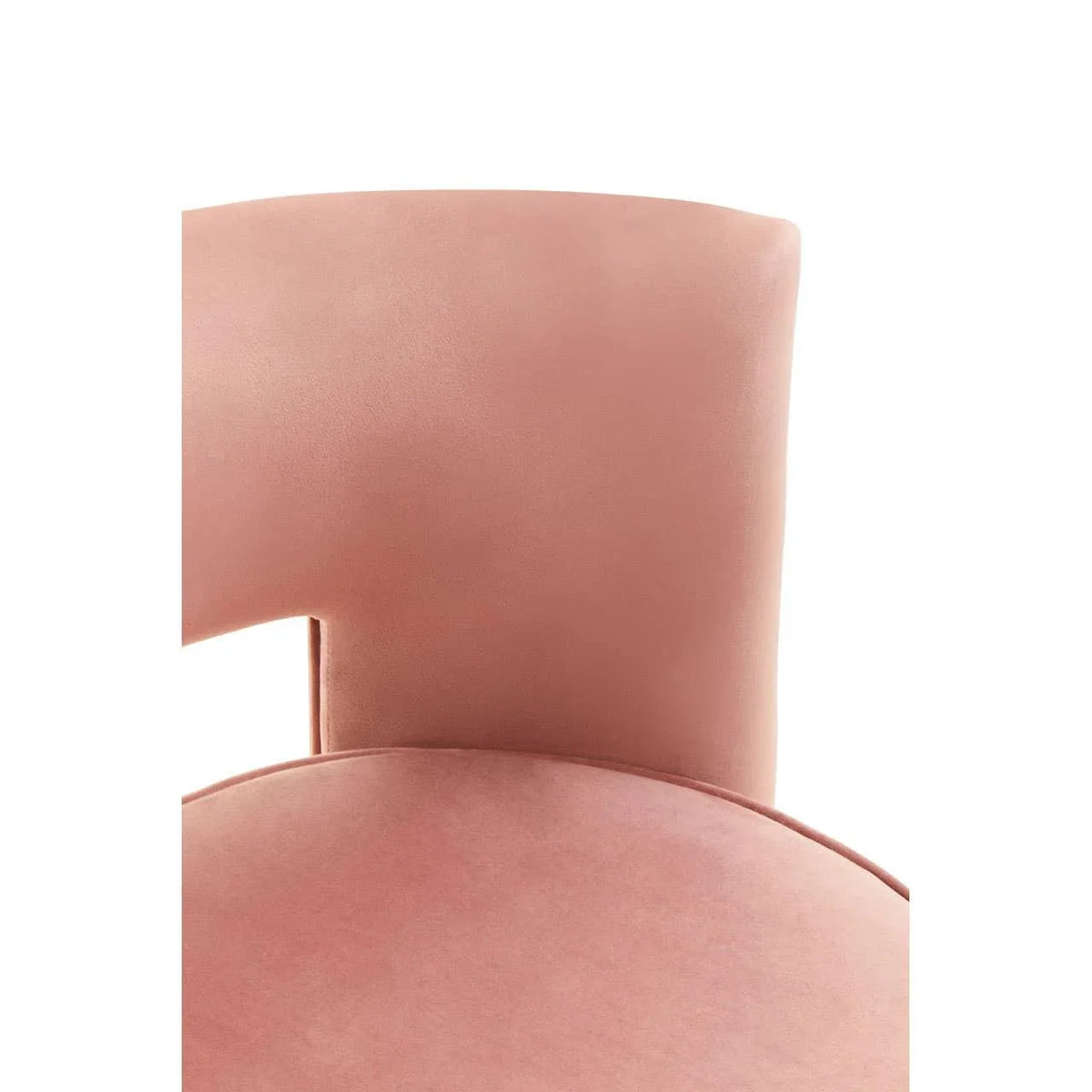 Blush pink velvet dining chair backrest close-up highlighting curved modern design