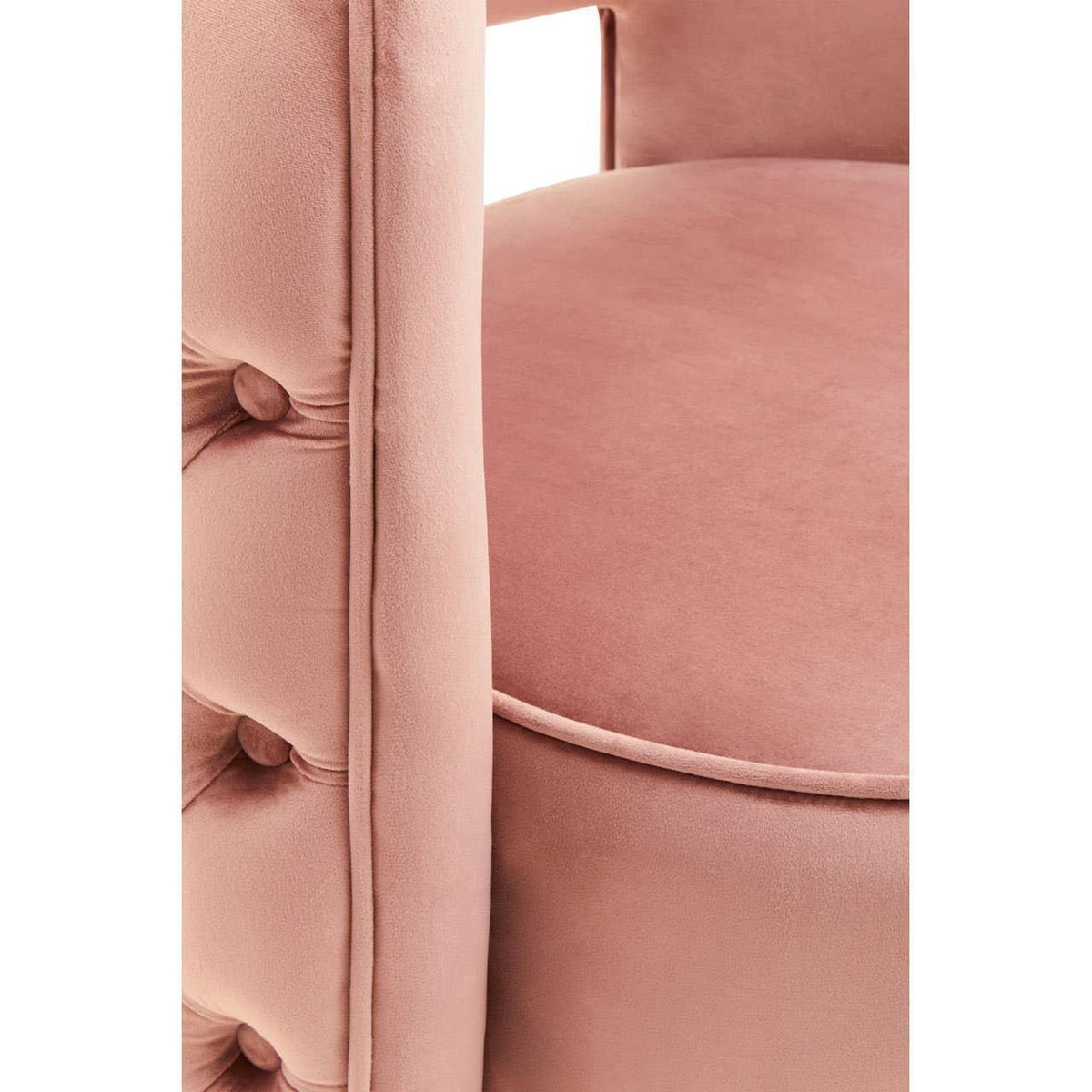 Blush pink velvet upholstered chair with button-tufted armrest and round seat