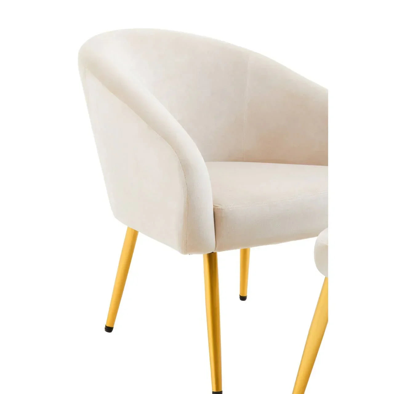Beige accent chair with curved backrest and gold metal legs, partial side view
