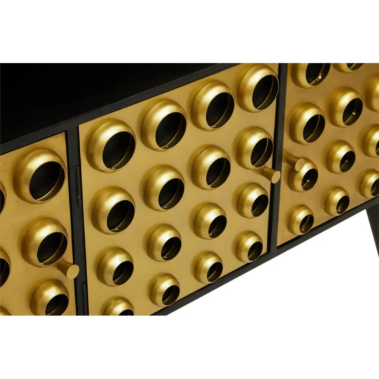 Close-up of gold metallic sideboard with circular embossed door panels and black frame