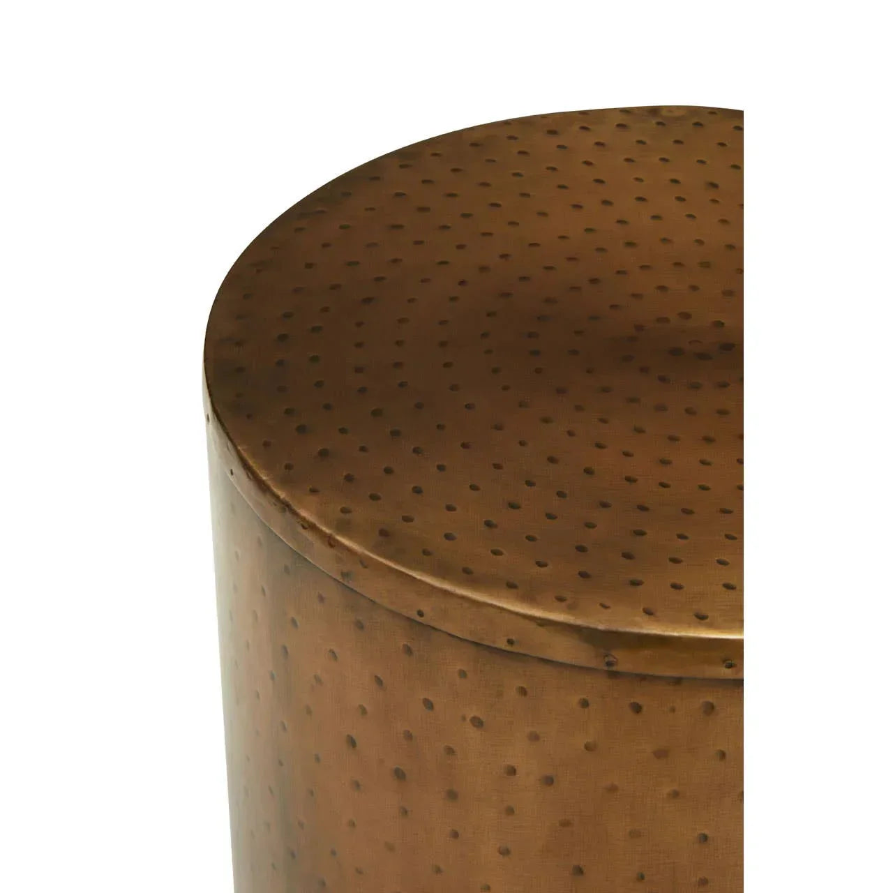 Round hammered brass side table with dotted texture, close-up of top surface