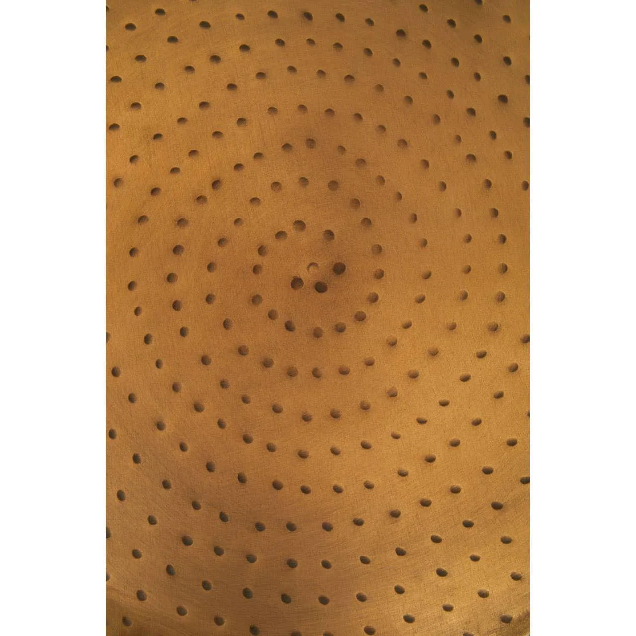 Close-up of perforated wooden seat with circular hole pattern