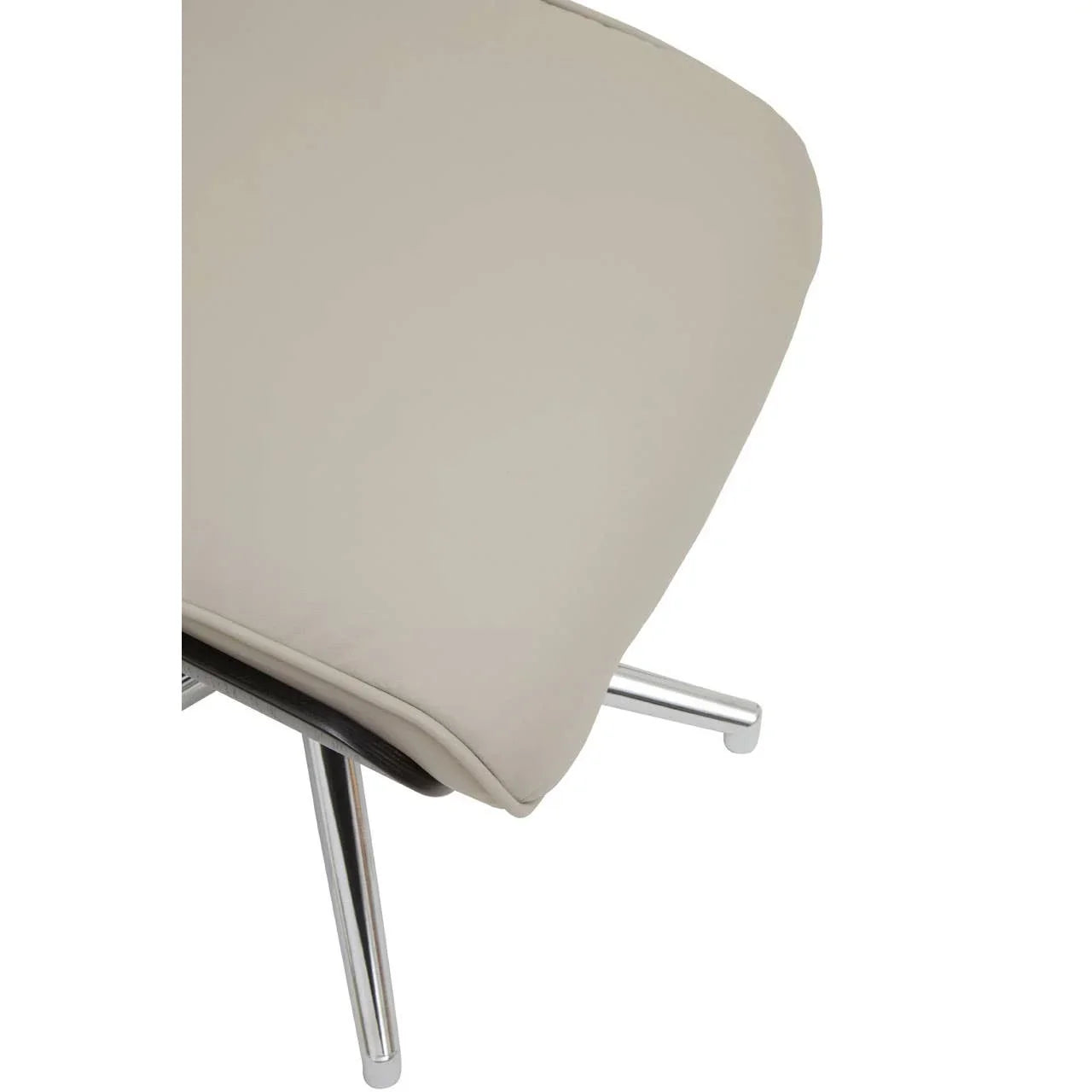 Close-up of beige dining chair cushion with chrome metal legs
