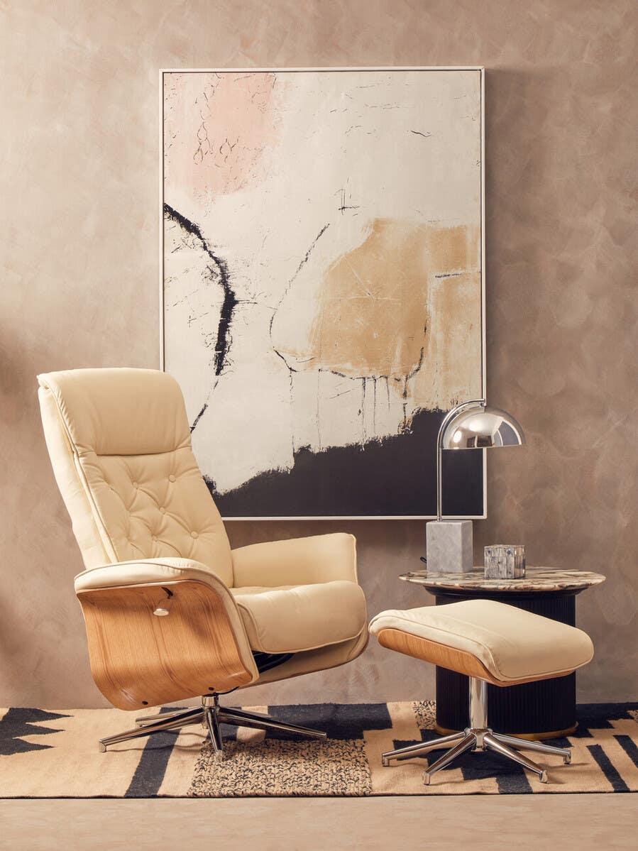 Cream leather recliner chair with matching footstool and marble side table in modern living room