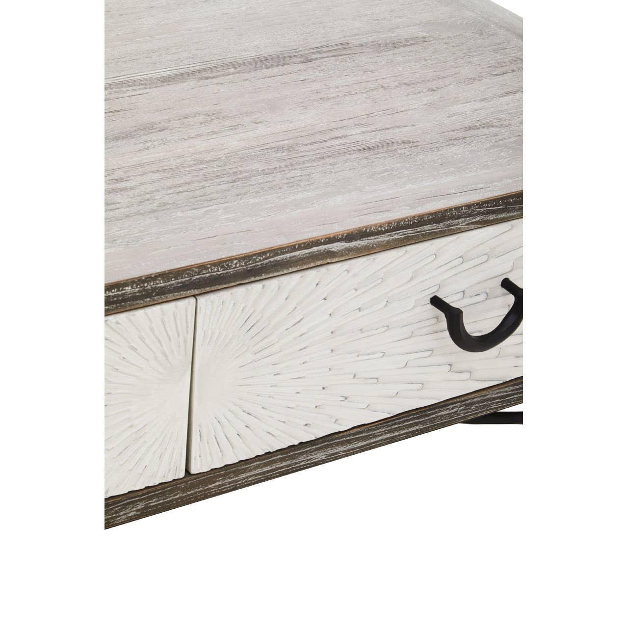 Whitewashed wooden coffee table corner with carved drawer and black metal handle