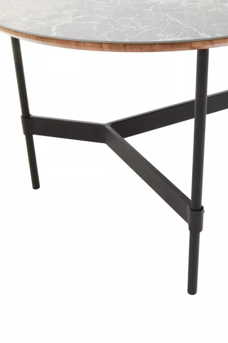 Round marble table top with black metal legs and wooden trim, close-up view