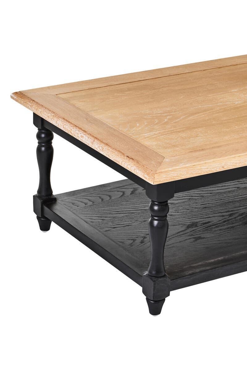 Rectangular wooden coffee table with natural top, black turned legs, and lower storage shelf