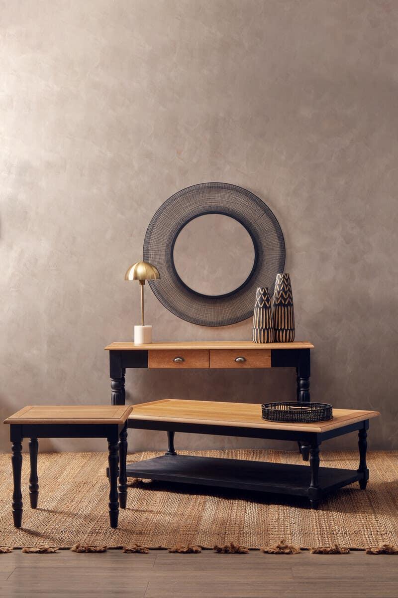 Black and oak wood coffee table set with geometric vases and round wall mirror