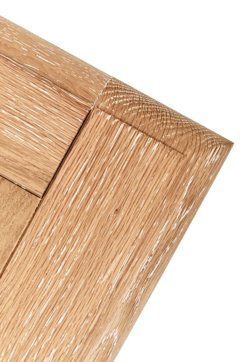 Close-up of oak wood table corner detailing grain and joint