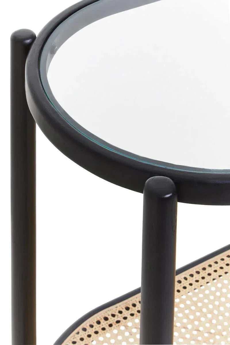 Round glass side table with black frame and cane shelf, close-up detail view