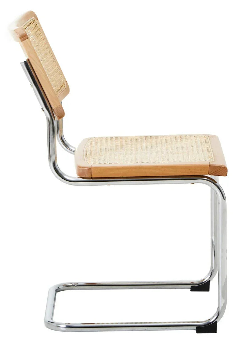 Side view of cane dining chair with chrome tubular frame and light wood accents