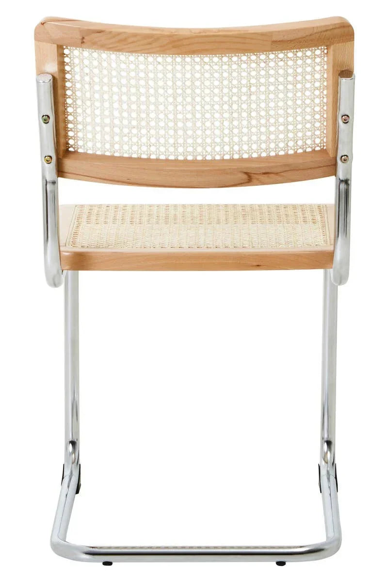 Cane dining chair with light wood frame and chrome cantilever legs, rear view