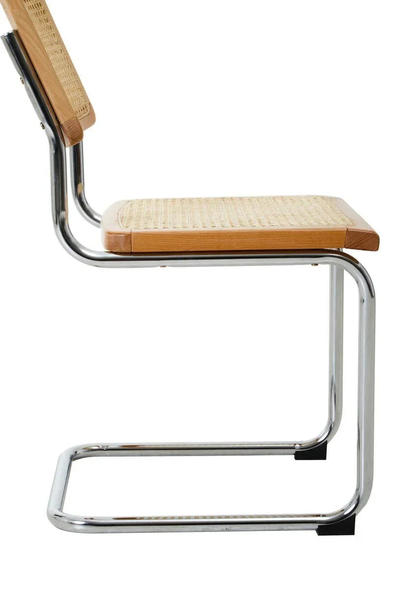 Side view of dining chair with chrome cantilever frame and woven rattan seat and backrest