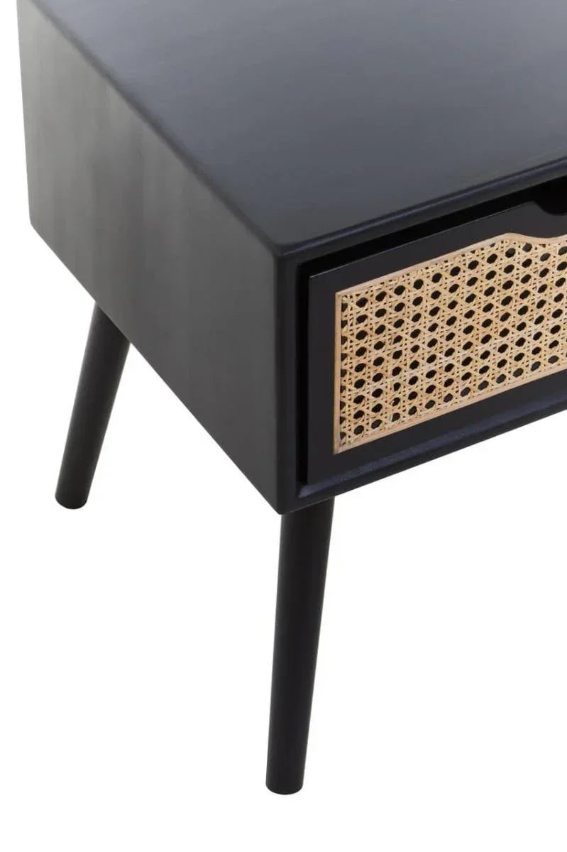 Black bedside table with cane front drawer and slender angled legs