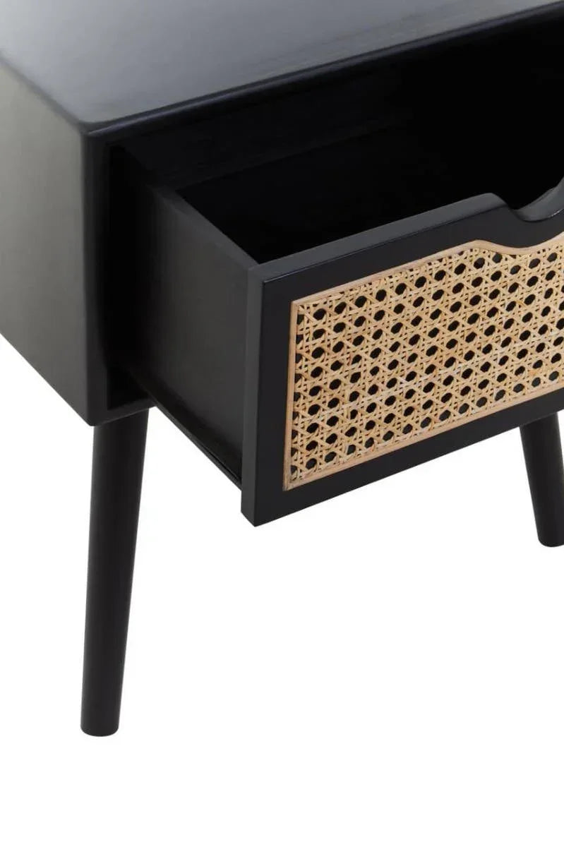 Black wooden bedside table with rattan drawer front and angled legs, drawer open
