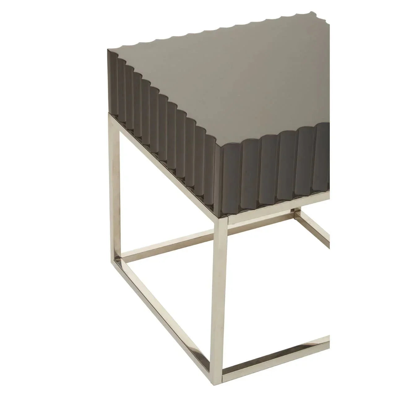 Modern side table with grey scalloped top and chrome metal frame, angled corner view