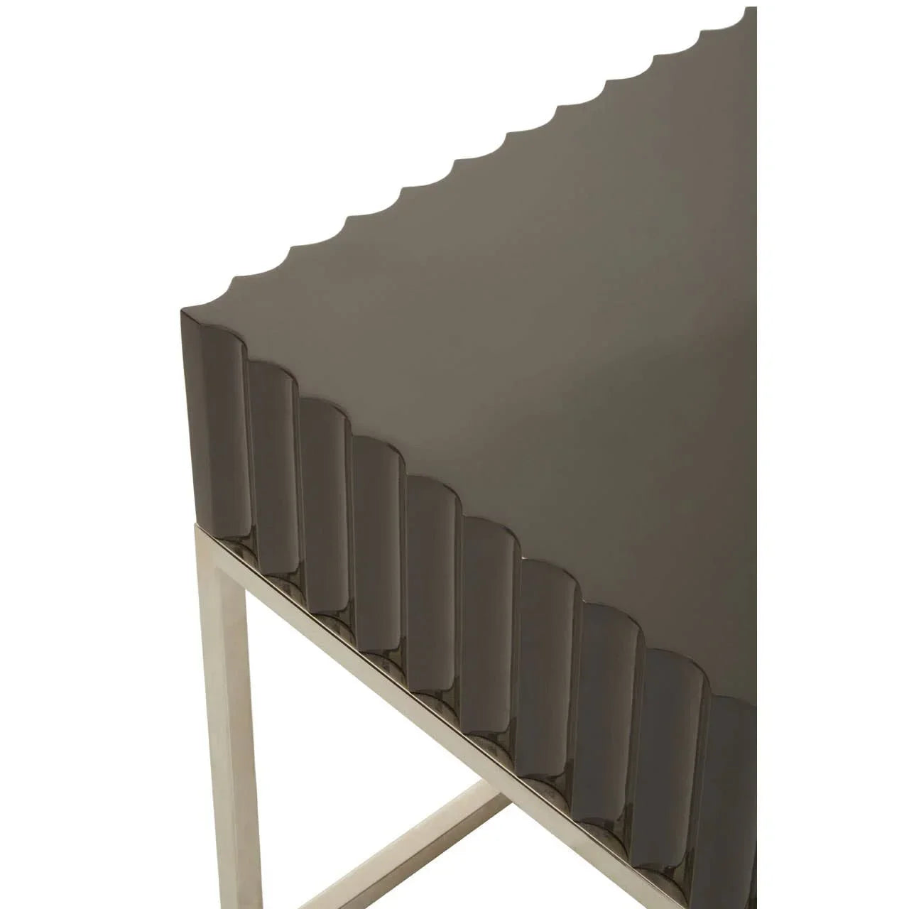 Contemporary side table with scalloped brown tabletop and chrome metal legs, corner view