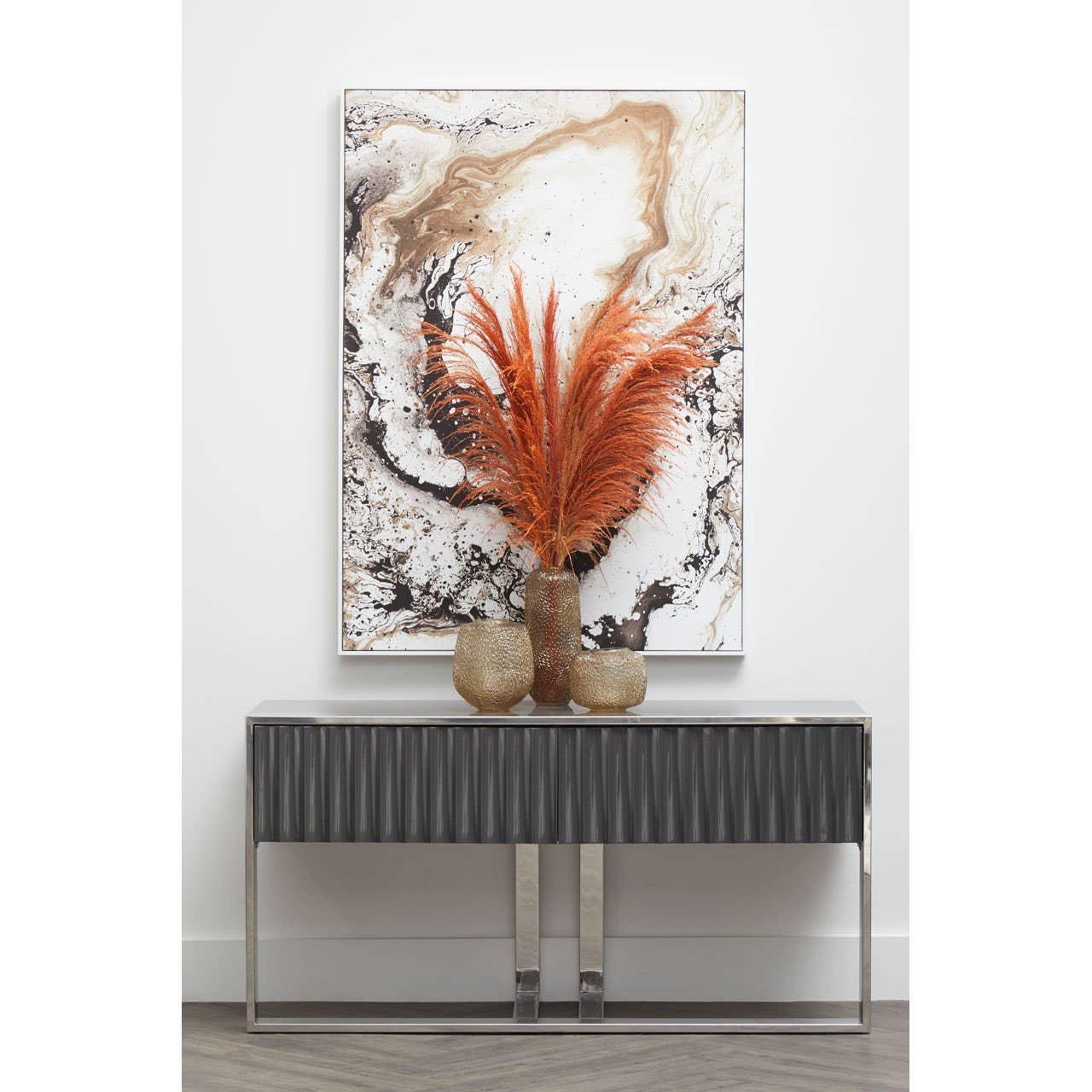 Black console table with textured front, gold vases and orange pampas grass, abstract art above