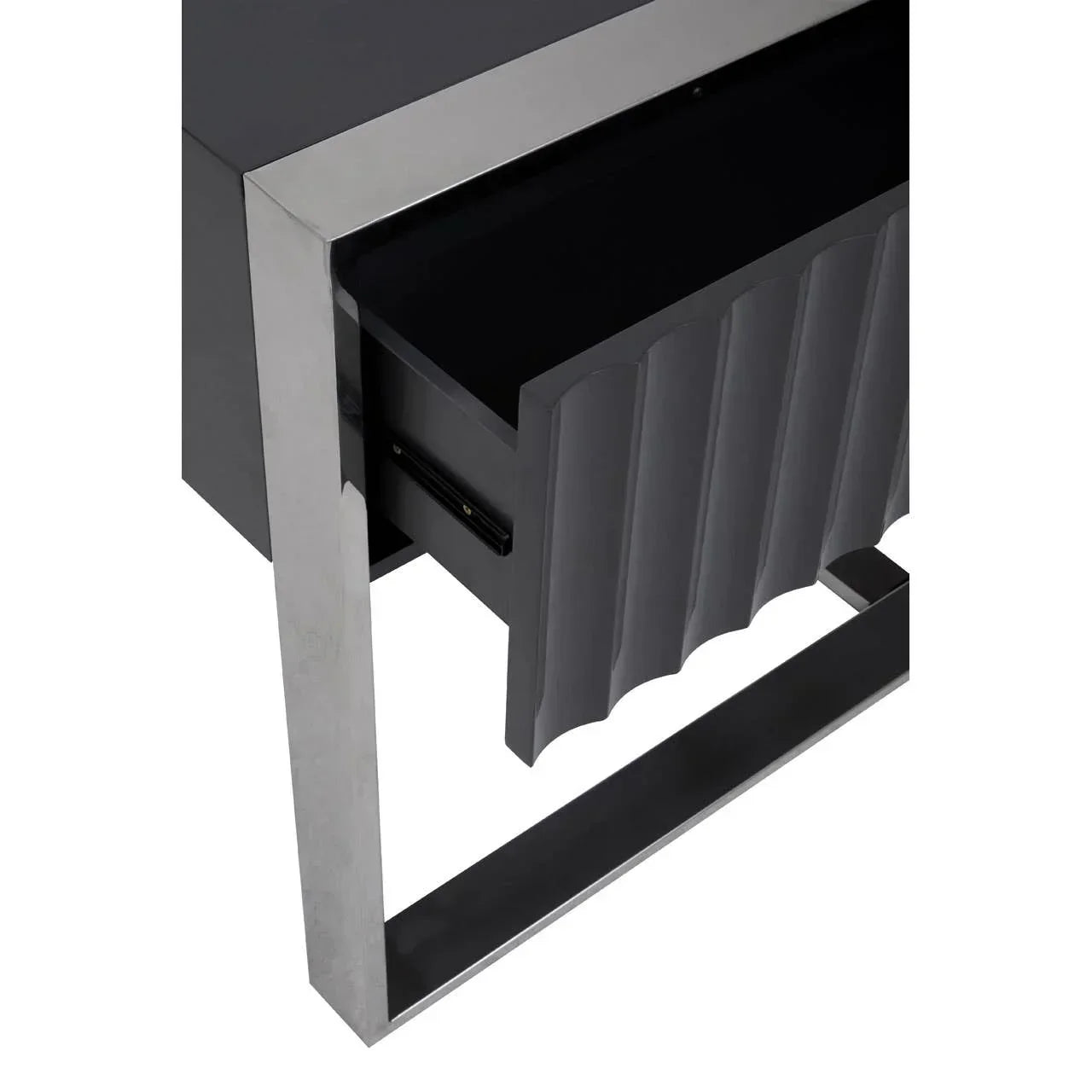 Black bedside table with metal frame and scalloped drawer front, close-up angle
