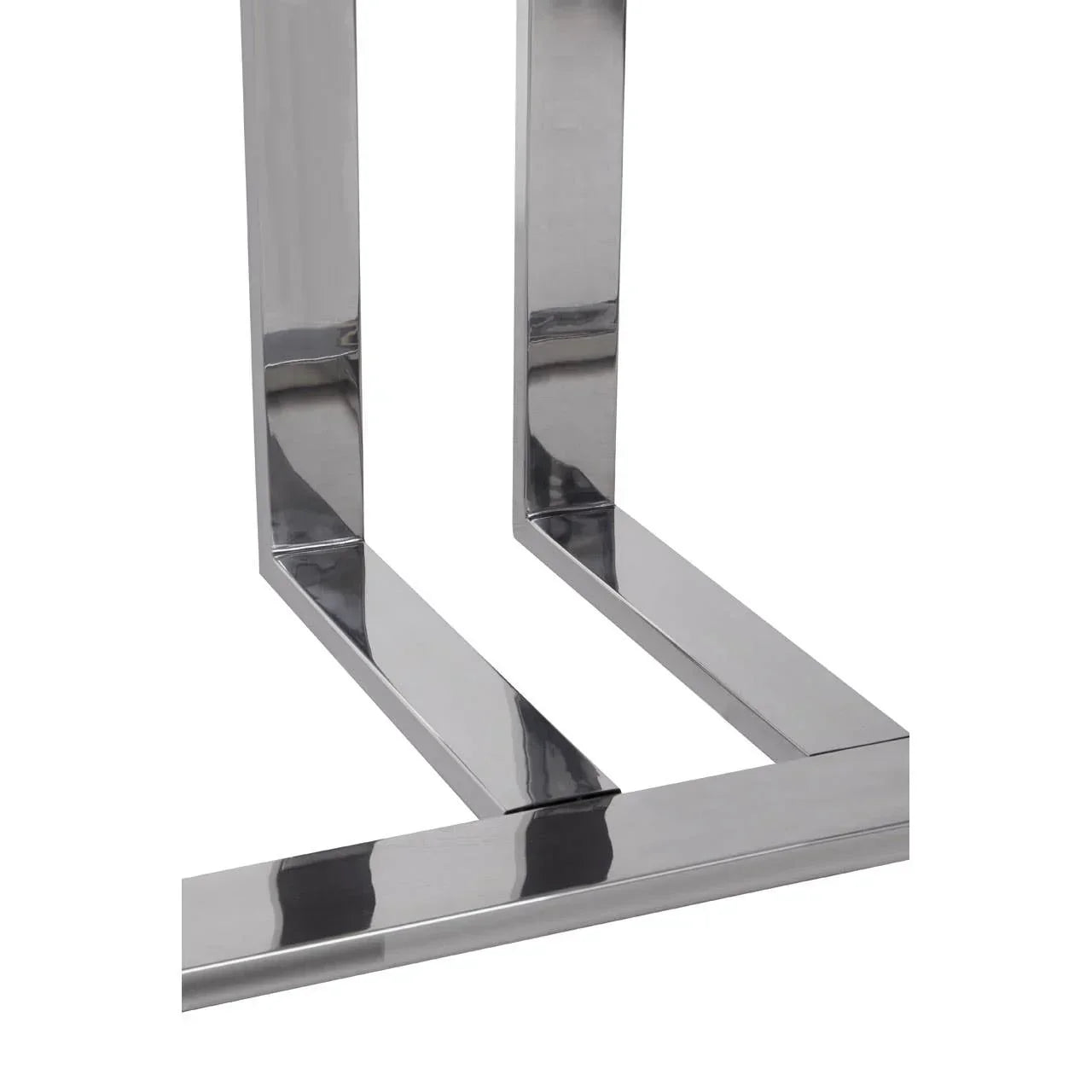 Close view of chrome metal table legs with a modern geometric design