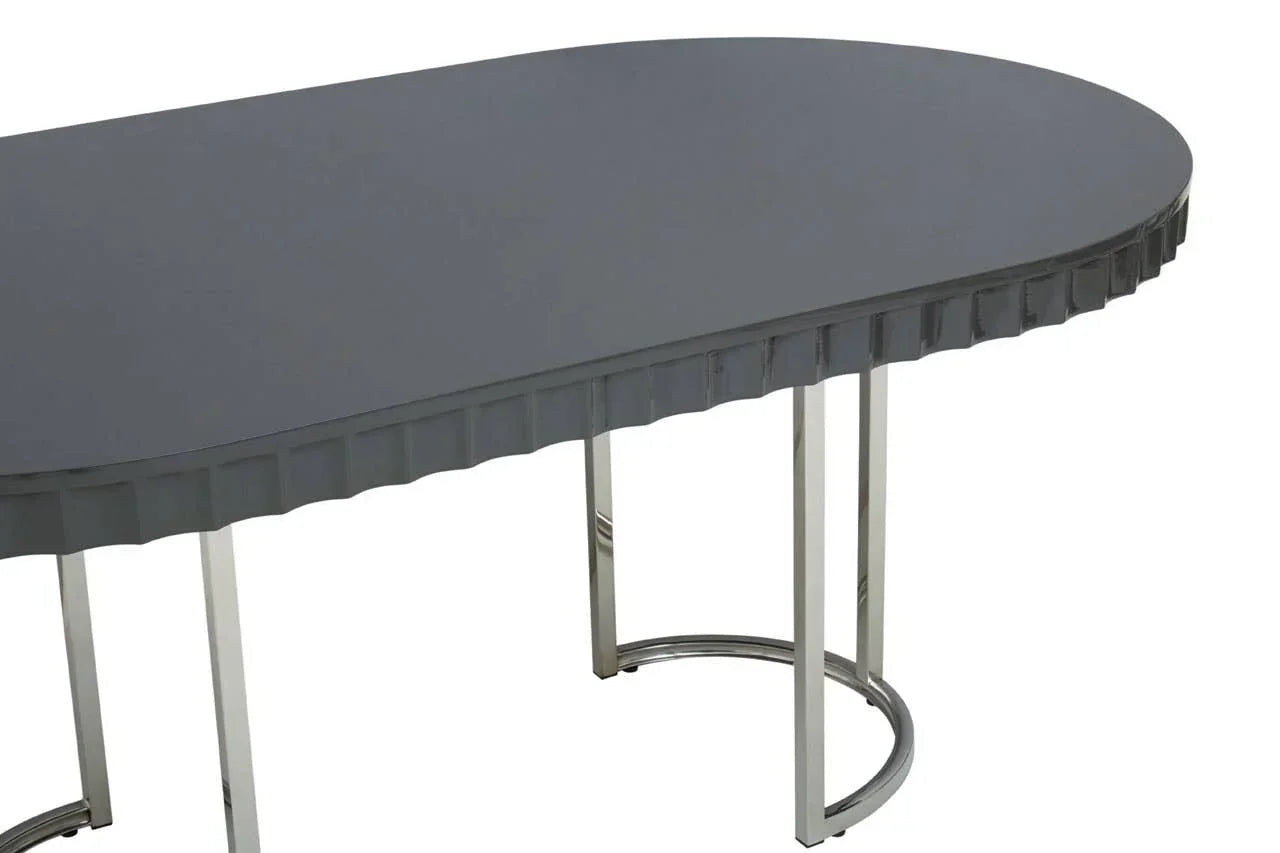 Grey oval dining table with textured edge and chrome metal legs