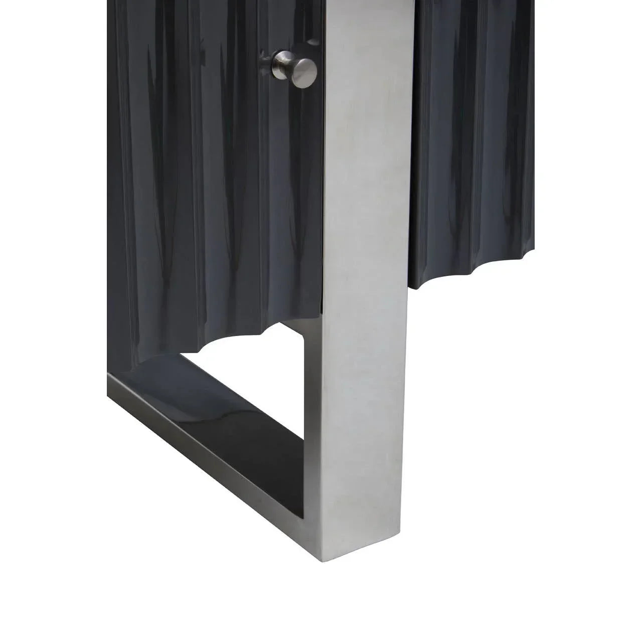 Black cabinet with vertical textured doors and brushed metal leg close-up
