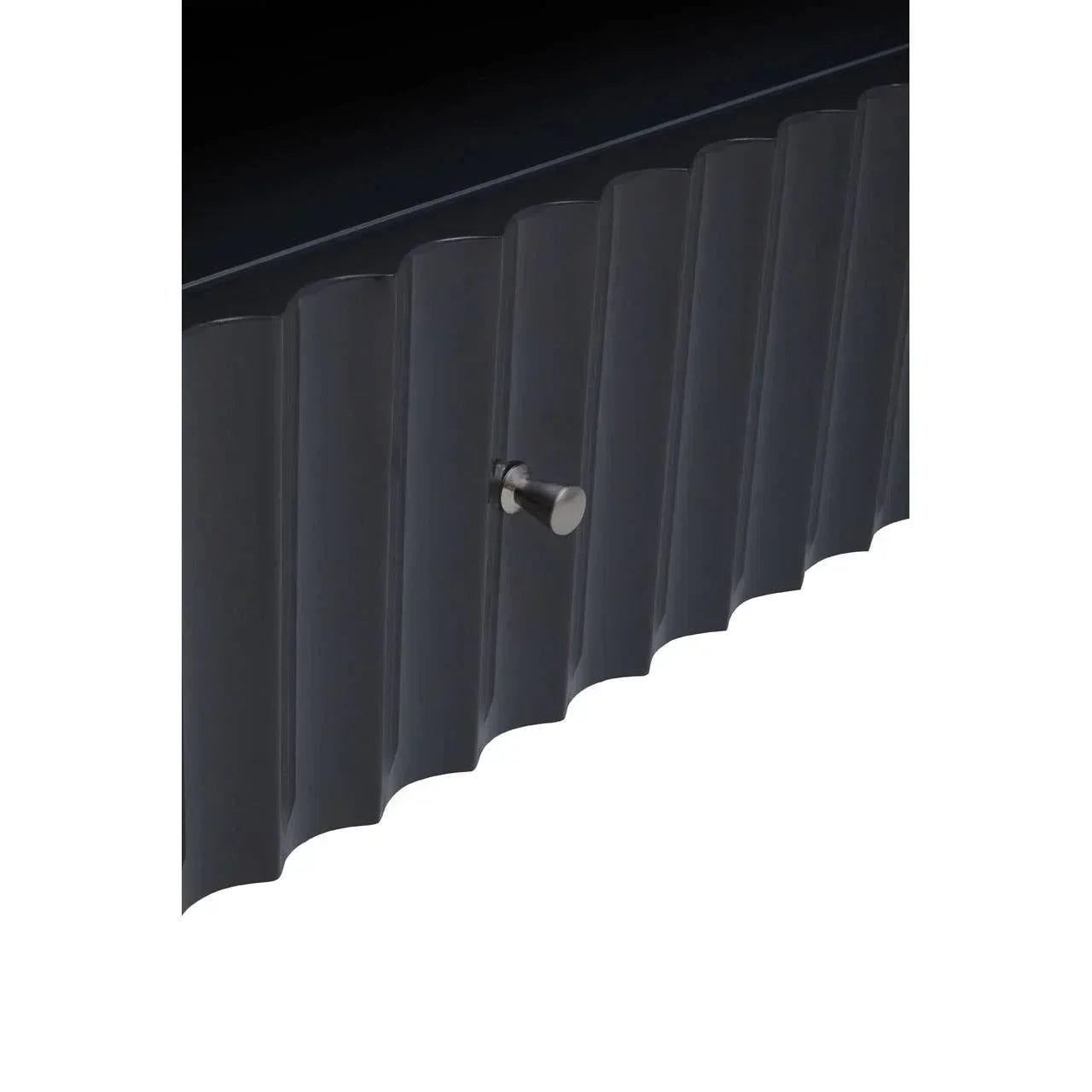 Closeup of black fluted cabinet door with metal handle, modern furniture detail