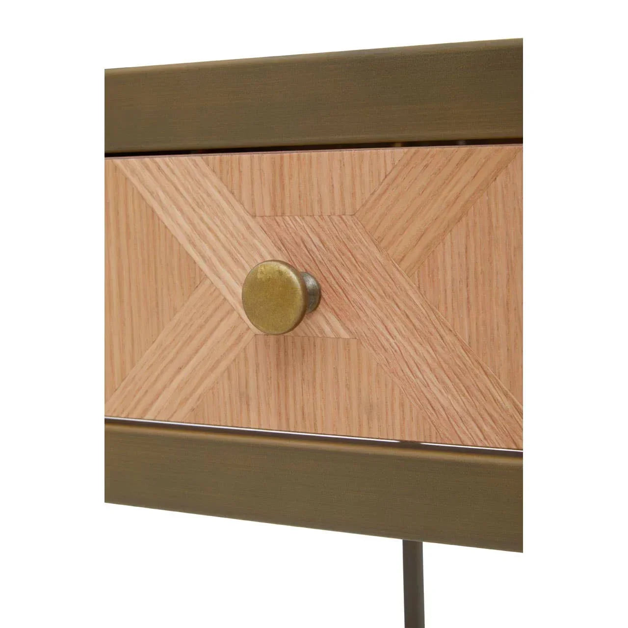 Closeup of wooden bedside table drawer with brass knob and geometric inlay pattern