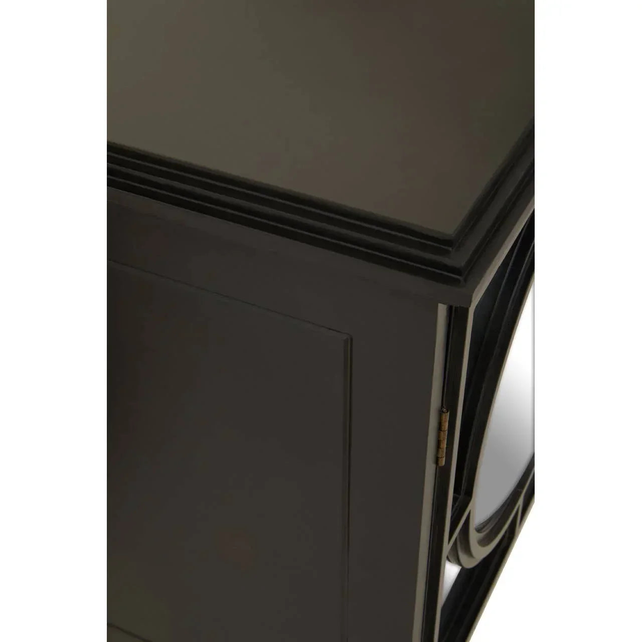 Close-up of black wooden cabinet corner with panel door and decorative trim