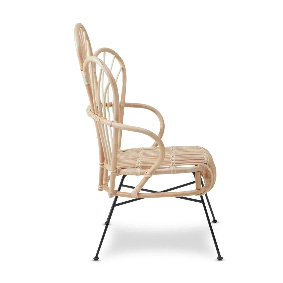 Natural rattan armchair with curved back and black metal legs, side profile view