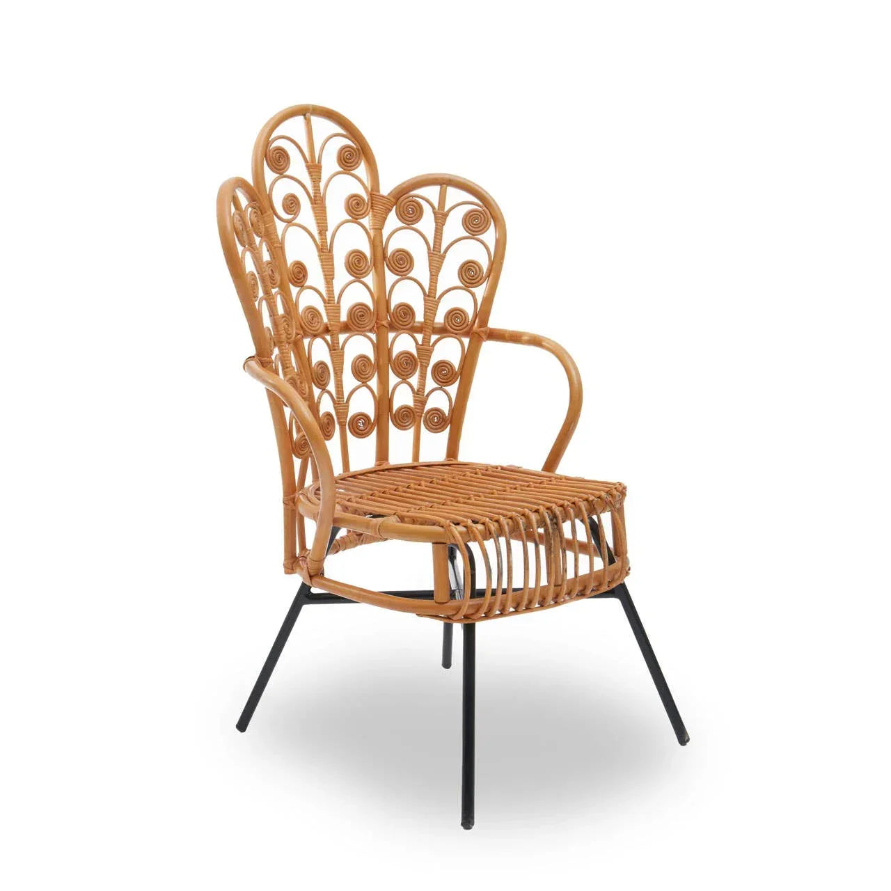 Natural rattan armchair with ornate scroll backrest and black metal legs, angled view