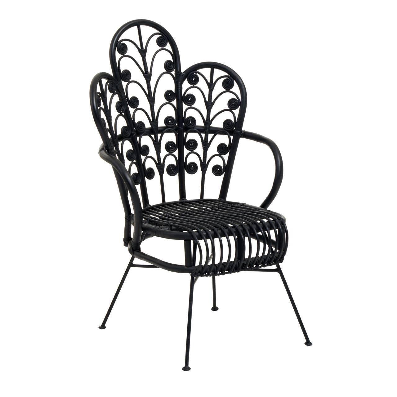 A black rattan chair with a scalloped back design featuring intricate leaf patterns, supported by slender metal legs. The chair has curved armrests and a woven seat, showcasing a blend of elegance and natural aesthetics