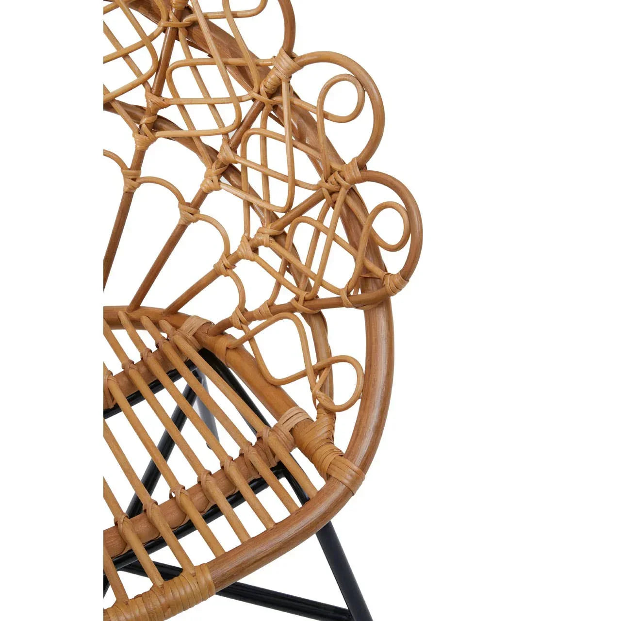Close-up of rattan chair backrest with intricate woven pattern and black metal legs