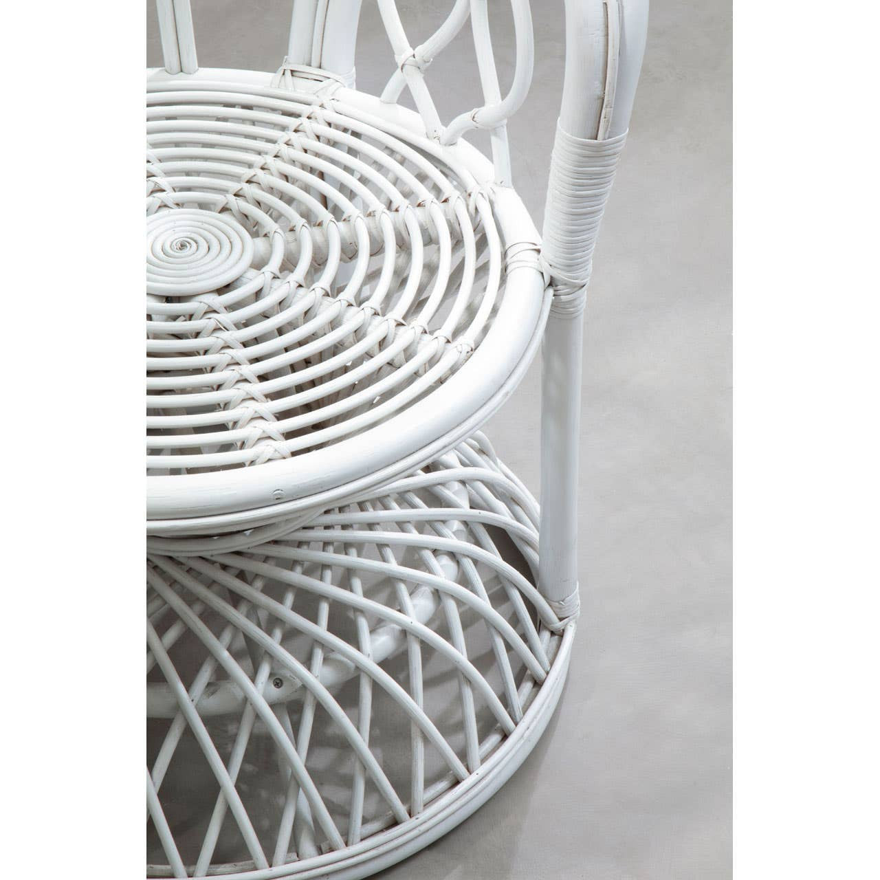 Curved chair featuring a natural rattan design with a grey and white color scheme, showcasing a round seat with a woven pattern and a sturdy base. The chair has a smooth, elegant silhouette and is placed on a neutral surface