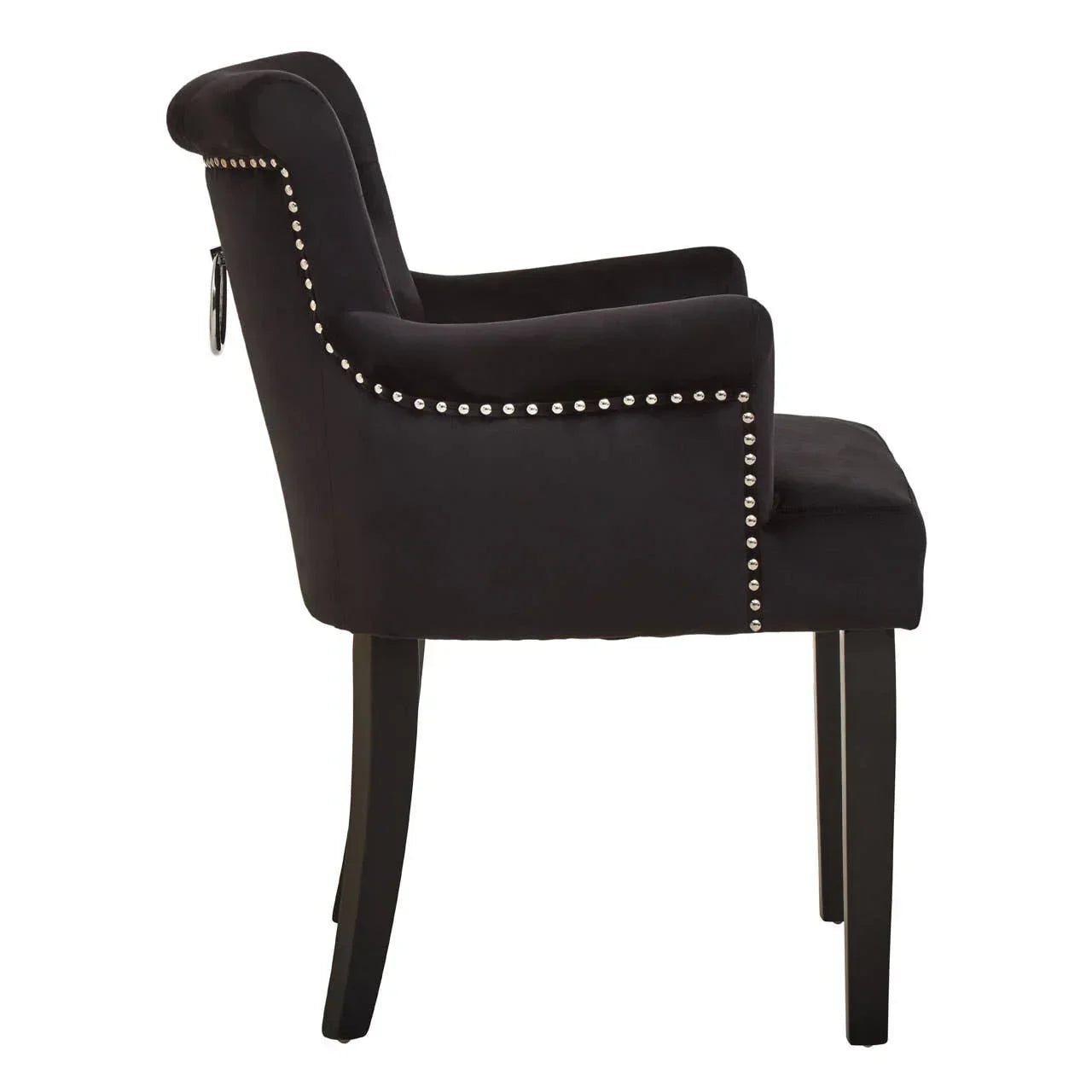 Black upholstered dining chair with silver stud trim, side view, dark wooden legs
