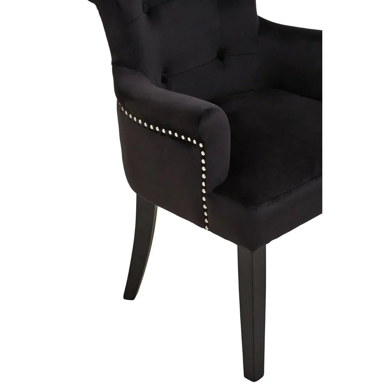 Black velvet dining chair with studded trim and button tufted backrest