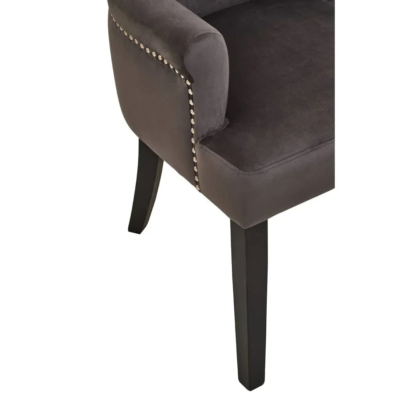 Grey velvet upholstered dining chair with nailhead trim and dark wood legs