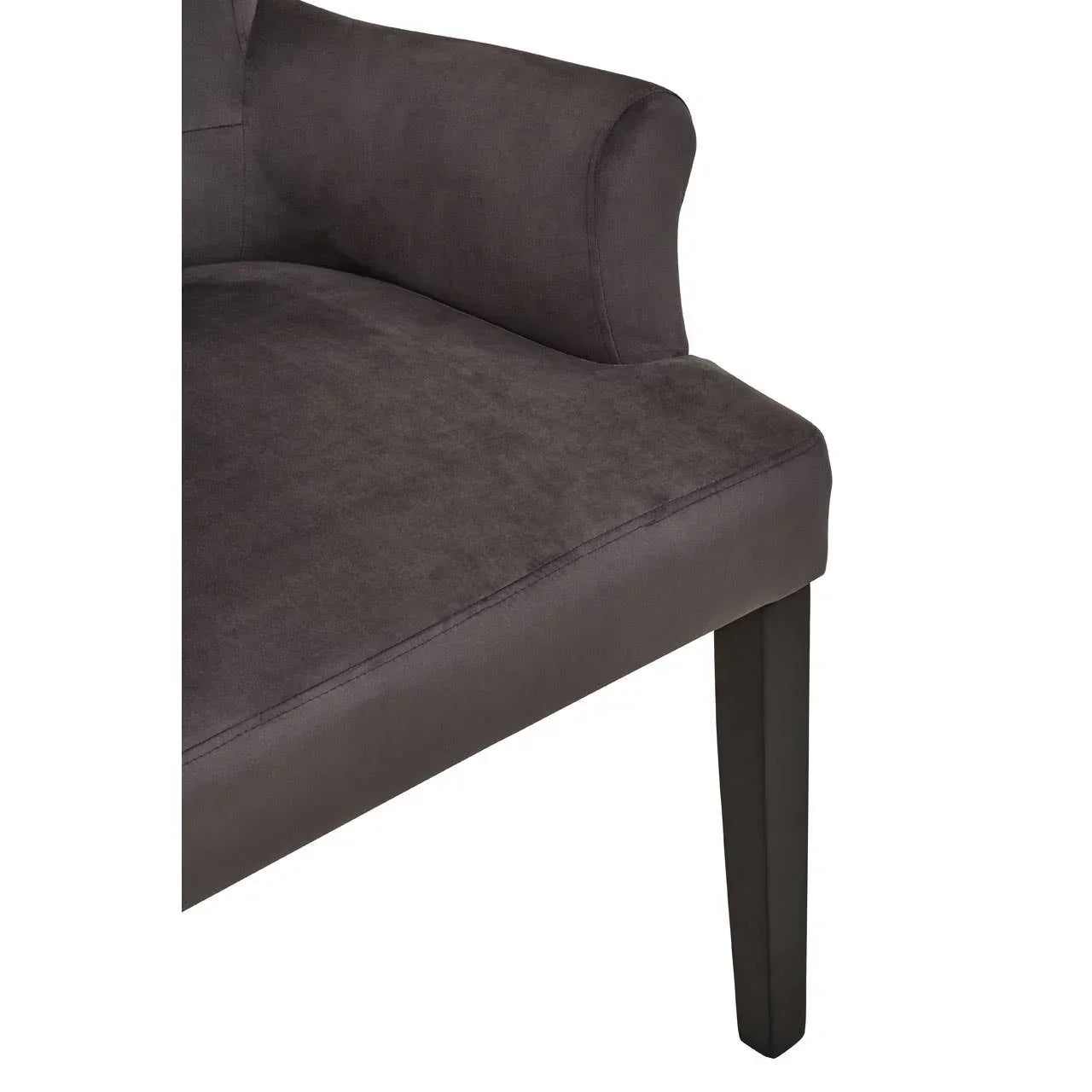 Close up of dark grey upholstered armchair seat and wooden leg