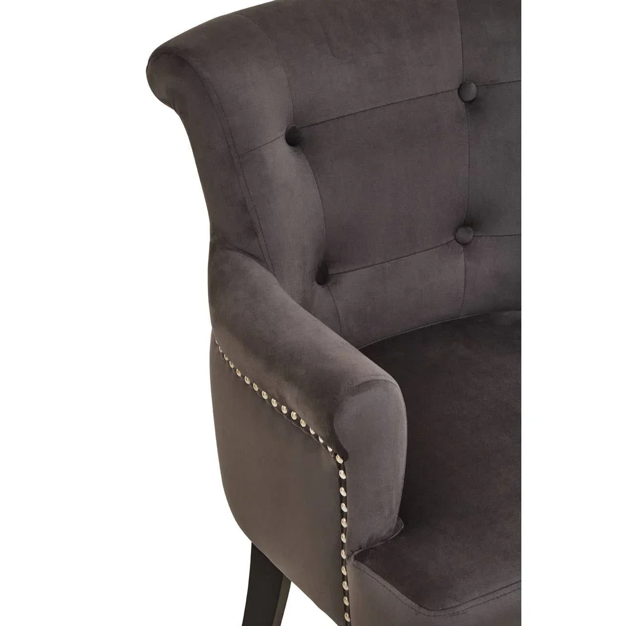 Charcoal velvet armchair with button tufting and silver stud detailing on armrest